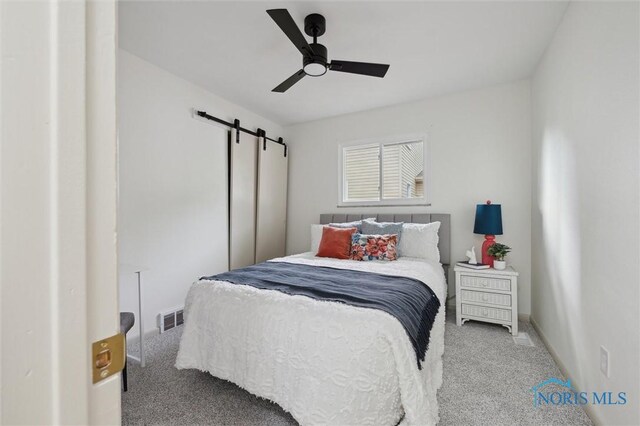 800 Pierce St, Maumee, OH 43537 - bedroom with carpet, a barn door, and ceiling fan