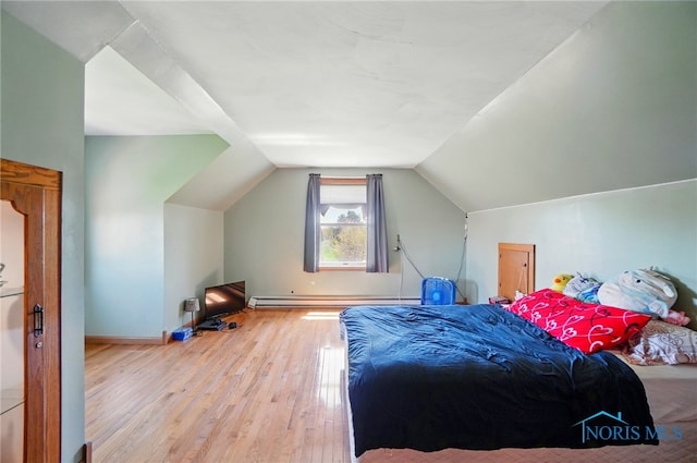 5450 Twp Rd 69, Tiffin, OH 44883 - bedroom with wood finished floors, baseboard heating, vaulted ceiling, and baseboards