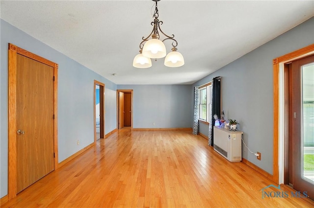 5450 Twp Rd 69, Tiffin, OH 44883 - spare room featuring light wood-style floors, a chandelier, and baseboards