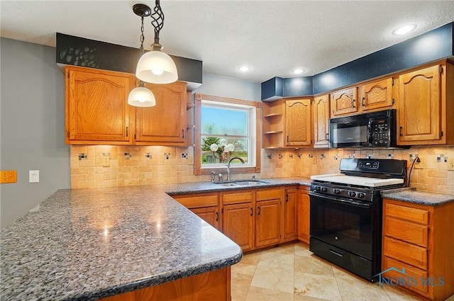 5450 Twp Rd 69, Tiffin, OH 44883 - kitchen featuring black appliances, a sink, a peninsula, and brown cabinetry