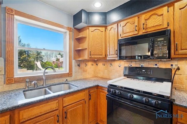 5450 Twp Rd 69, Tiffin, OH 44883 - kitchen with black appliances, a sink, backsplash, dark stone countertops, and brown cabinetry