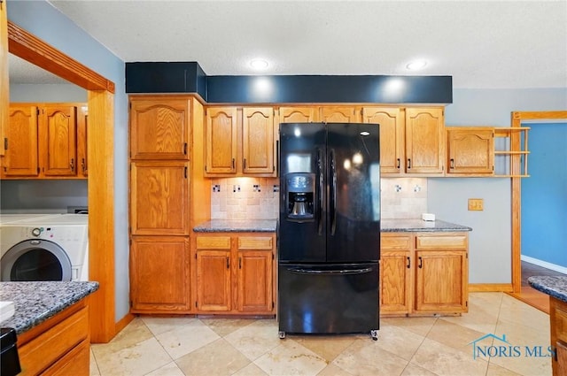 5450 Twp Rd 69, Tiffin, OH 44883 - kitchen with black refrigerator with ice dispenser, stone countertops, tasteful backsplash, washer and dryer, and baseboards