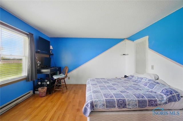 5450 Twp Rd 69, Tiffin, OH 44883 - bedroom with baseboard heating and wood finished floors