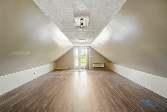 5450 Twp Rd 69, Tiffin, OH 44883 - bonus room with wood finished floors, vaulted ceiling, a wall unit AC, and a textured ceiling