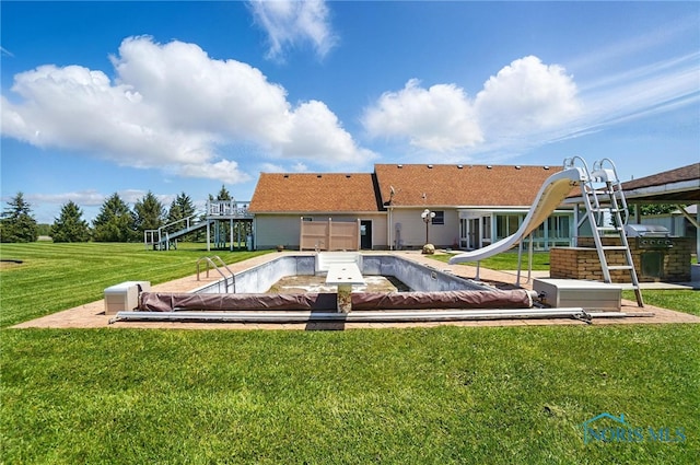 5450 Twp Rd 69, Tiffin, OH 44883 - rear view of property with a lawn and a covered pool