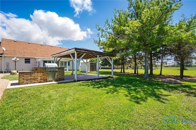 5450 Twp Rd 69, Tiffin, OH 44883 - view of home's community with a storage unit, an outdoor kitchen, an outbuilding, a yard, and a carport