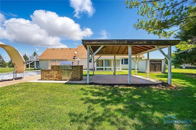 5450 Twp Rd 69, Tiffin, OH 44883 - rear view of property with an outdoor kitchen, a patio, a lawn, and a detached carport