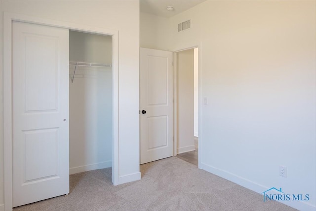 1089 Springcrest Dr, Waterville, OH 43566 - unfurnished bedroom featuring light colored carpet, baseboards, and a closet