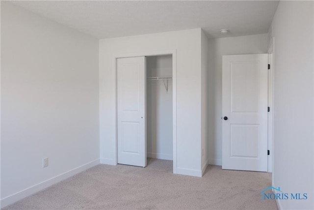 1089 Springcrest Dr, Waterville, OH 43566 - unfurnished bedroom with light colored carpet, a closet, and baseboards