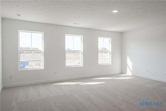1089 Springcrest Dr, Waterville, OH 43566 - unfurnished room featuring carpet, a textured ceiling, baseboards, recessed lighting, and a smoke detector
