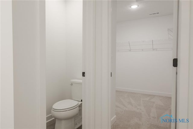1089 Springcrest Dr, Waterville, OH 43566 - bathroom with baseboards, toilet, a walk in closet, and recessed lighting