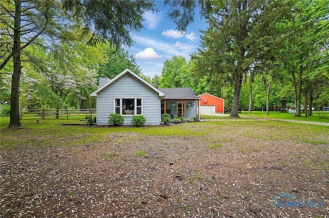 9544 Maumee Western Rd, Monclova, OH 43542 - view of property exterior featuring fence, a detached garage, and a chimney