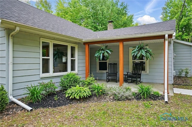 9544 Maumee Western Rd, Monclova, OH 43542 - property entrance featuring roof with shingles, a chimney, and covered porch