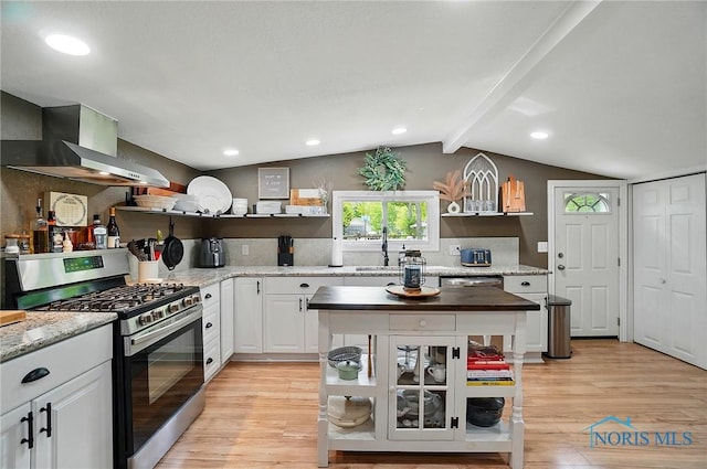 9544 Maumee Western Rd, Monclova, OH 43542 - kitchen with open shelves, stainless steel appliances, wall chimney exhaust hood, light wood-style floors, and white cabinets