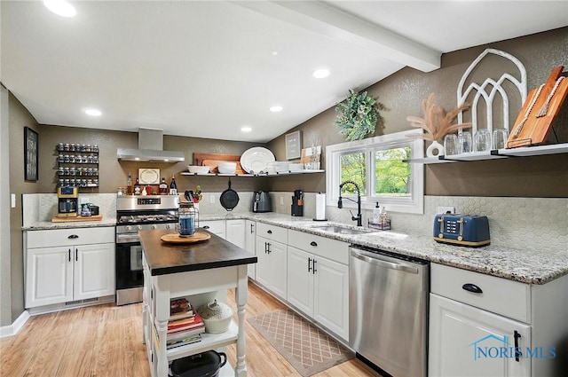 9544 Maumee Western Rd, Monclova, OH 43542 - kitchen with open shelves, stainless steel appliances, a sink, wall chimney exhaust hood, and light wood-style floors