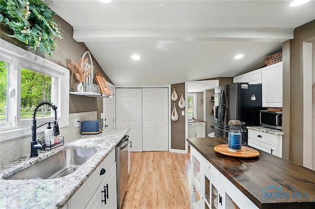 9544 Maumee Western Rd, Monclova, OH 43542 - kitchen with stainless steel appliances, a sink, light wood-type flooring, white cabinets, and dark stone countertops