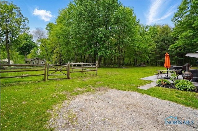 9544 Maumee Western Rd, Monclova, OH 43542 - view of yard featuring a patio area, a gate, and view of wooded area