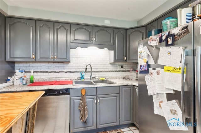 6690 County Road 219, Bellevue, OH 44811 - kitchen featuring stainless steel appliances, a sink, tasteful backsplash, and gray cabinets