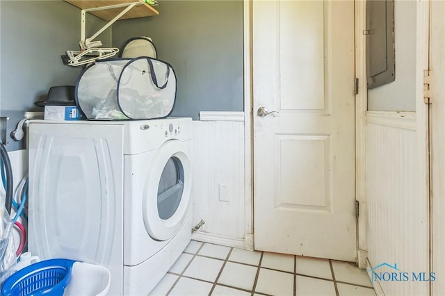 6690 County Road 219, Bellevue, OH 44811 - laundry area featuring washer / clothes dryer, a wainscoted wall, and electric panel