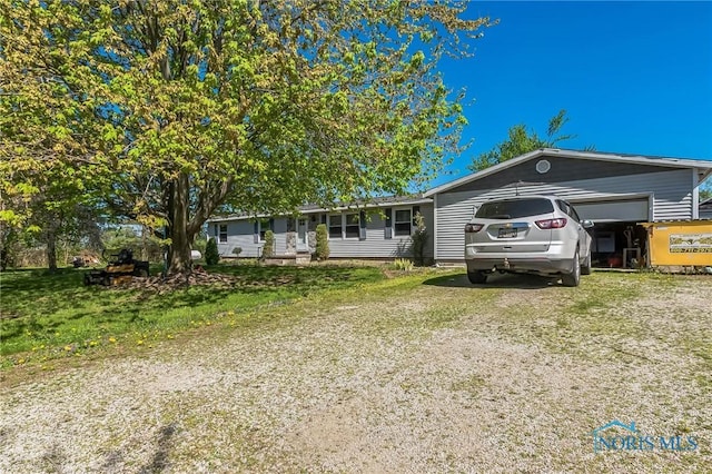 6690 County Road 219, Bellevue, OH 44811 - ranch-style house featuring driveway and an attached garage