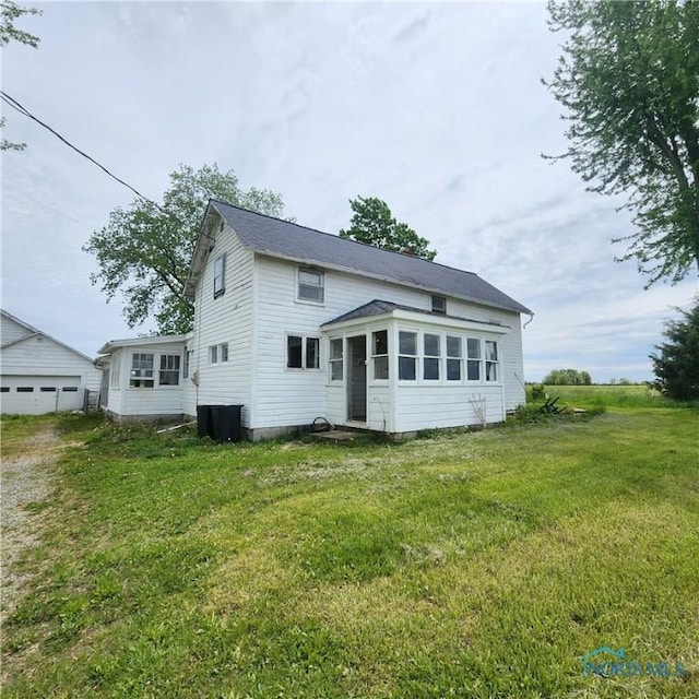 12101 County Highway 110, Upper Sandusky, OH 43351 - back of house featuring a lawn and a sunroom
