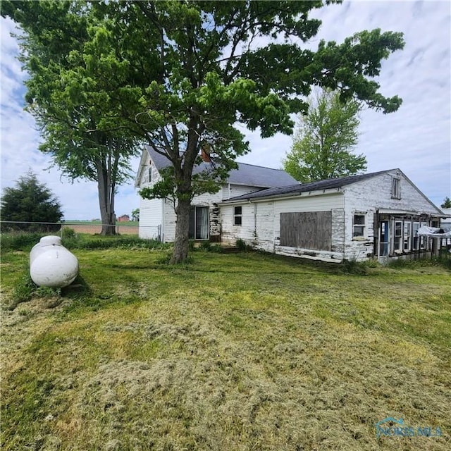 12101 County Highway 110, Upper Sandusky, OH 43351 - rear view of house featuring stone siding and a lawn