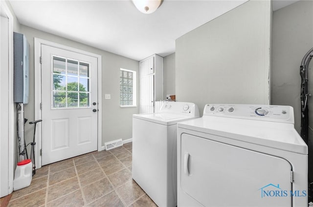 21 Pennsylvania Ave, Waterville, OH 43566 - laundry room featuring washing machine and dryer, baseboards, and light stone finish flooring