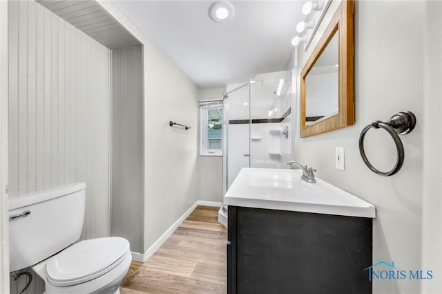 21 Pennsylvania Ave, Waterville, OH 43566 - full bath featuring wood finished floors, a shower stall, toilet, vanity, and baseboards