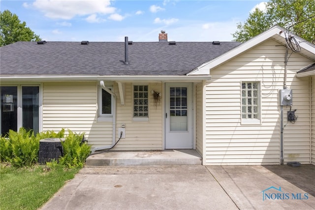 21 Pennsylvania Ave, Waterville, OH 43566 - back of house featuring roof with shingles, a chimney, cooling unit, and a patio area