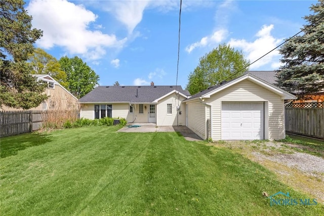 21 Pennsylvania Ave, Waterville, OH 43566 - back of property featuring driveway, a detached garage, and a patio