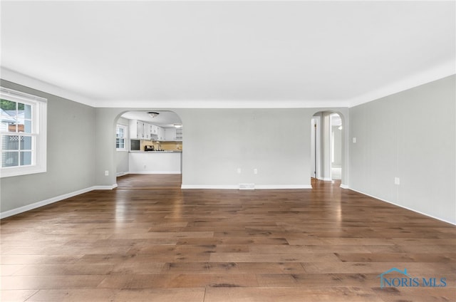 21 Pennsylvania Ave, Waterville, OH 43566 - unfurnished living room with arched walkways and wood finished floors