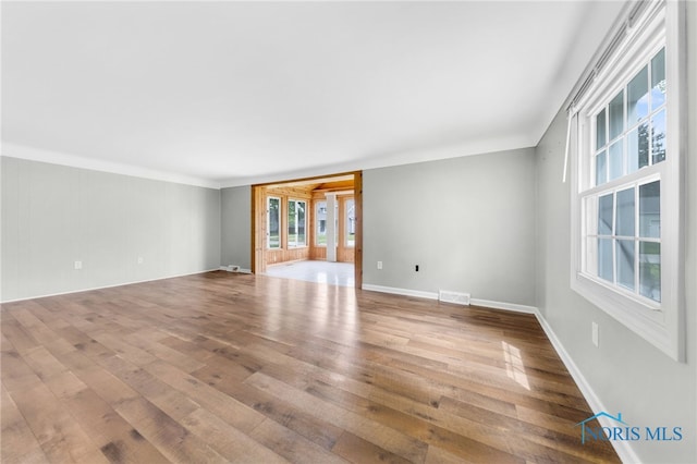21 Pennsylvania Ave, Waterville, OH 43566 - empty room featuring hardwood / wood-style flooring, plenty of natural light, and baseboards
