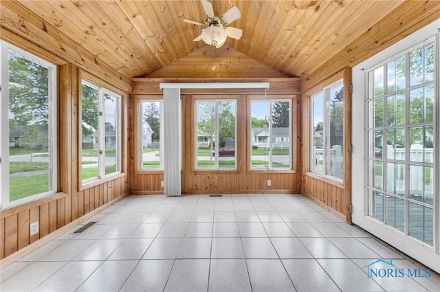 21 Pennsylvania Ave, Waterville, OH 43566 - unfurnished sunroom featuring lofted ceiling, wooden walls, plenty of natural light, tile patterned flooring, and baseboards