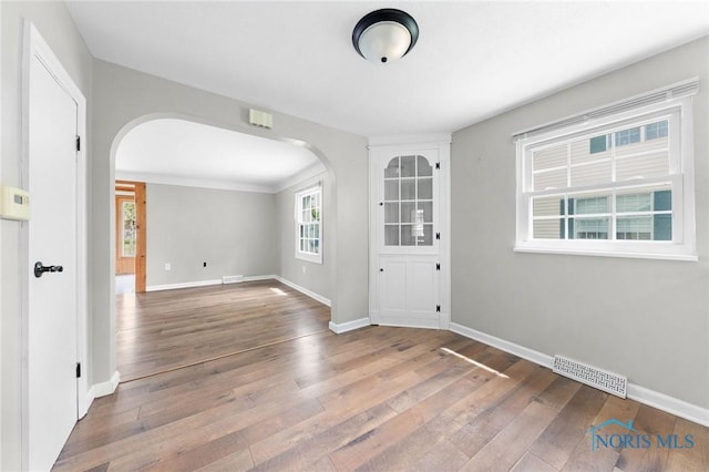 21 Pennsylvania Ave, Waterville, OH 43566 - unfurnished room featuring arched walkways, hardwood / wood-style flooring, and baseboards