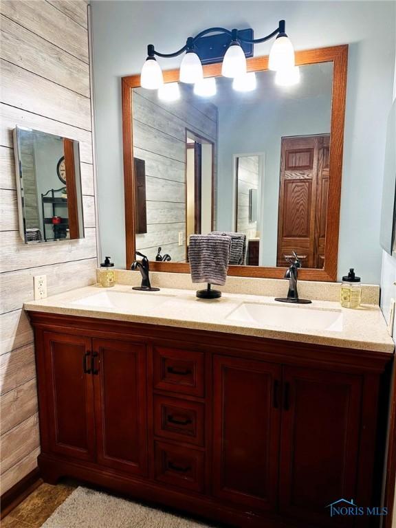 41 Salome Cir, Bluffton, OH 45817 - bathroom featuring double vanity and wooden walls