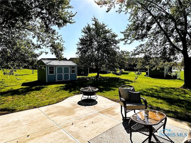41 Salome Cir, Bluffton, OH 45817 - view of patio featuring an outdoor fire pit, an outdoor structure, and a storage shed