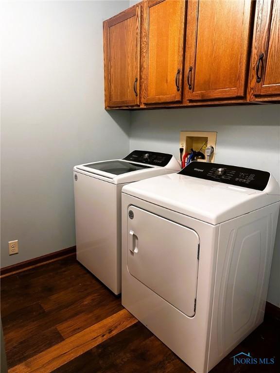 41 Salome Cir, Bluffton, OH 45817 - washroom featuring cabinet space, separate washer and dryer, dark wood-style floors, and baseboards