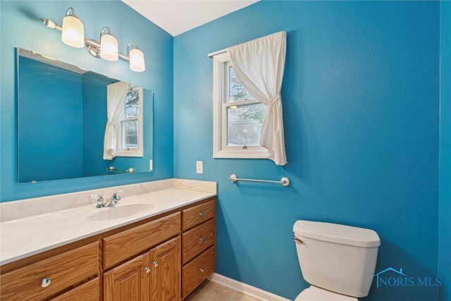 1208 Lindau St, Archbold, OH 43502 - bathroom with toilet, vanity, and baseboards