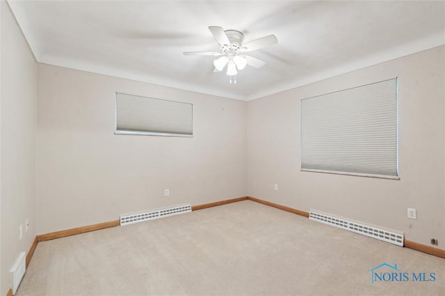 1208 Lindau St, Archbold, OH 43502 - empty room with a baseboard radiator, carpet, ceiling fan, and baseboards