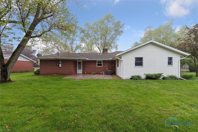 1208 Lindau St, Archbold, OH 43502 - rear view of house with a patio area, a yard, a chimney, and central AC