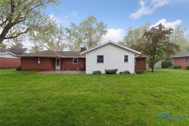 1208 Lindau St, Archbold, OH 43502 - rear view of property featuring a yard, a chimney, and central AC