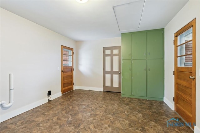 1208 Lindau St, Archbold, OH 43502 - empty room featuring attic access, stone finish flooring, and baseboards