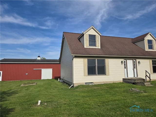 5924 N Reiman Rd, Curtice, OH 43412 - rear view of property featuring a yard and an outbuilding