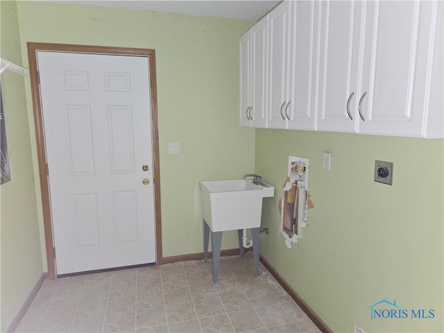 5924 N Reiman Rd, Curtice, OH 43412 - laundry area with cabinet space, electric dryer hookup, and baseboards