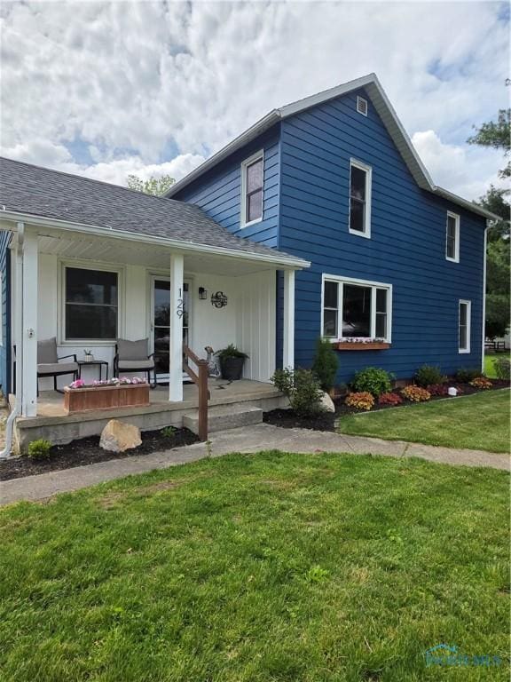 129 Stahl St, Bradner, OH 43406 - view of front of home featuring a porch and a front lawn