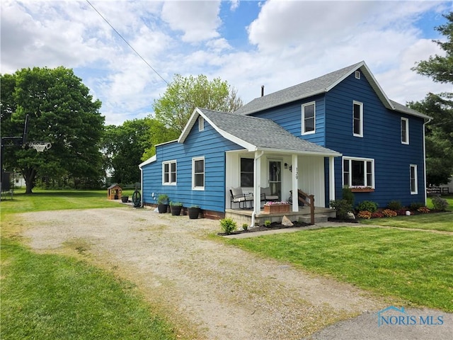 129 Stahl St, Bradner, OH 43406 - view of front facade with covered porch, dirt driveway, a front lawn, and roof with shingles