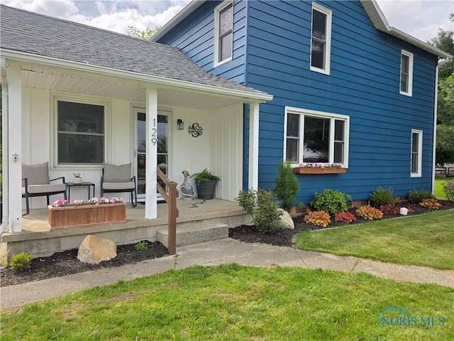 129 Stahl St, Bradner, OH 43406 - property entrance featuring covered porch, a yard, and a shingled roof