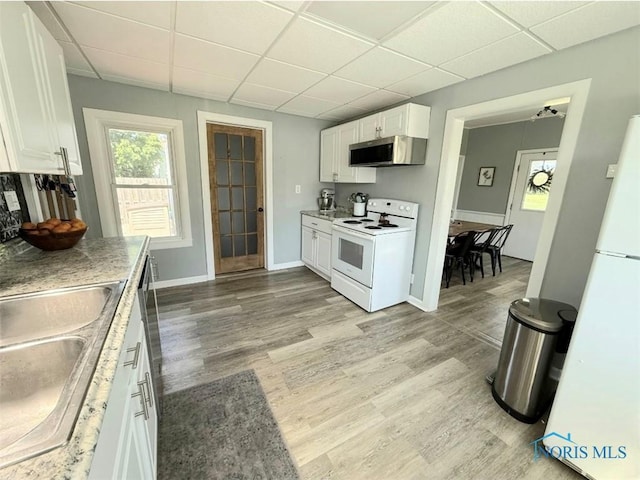 129 Stahl St, Bradner, OH 43406 - kitchen featuring white appliances, a paneled ceiling, white cabinets, a sink, and light wood-style flooring