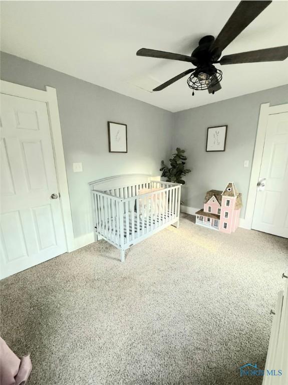 129 Stahl St, Bradner, OH 43406 - bedroom with carpet, a crib, a ceiling fan, and baseboards
