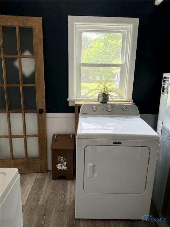 129 Stahl St, Bradner, OH 43406 - washroom featuring washer and clothes dryer, a wainscoted wall, wood finished floors, and gas water heater